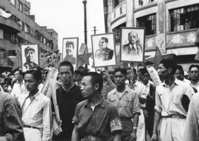 A crowd parading the portraits of Zhu De, Mao Zedong, Joseph Stalin and Vladimir Lenin, from Shanghai: 1949 The End of an Era, 1949.